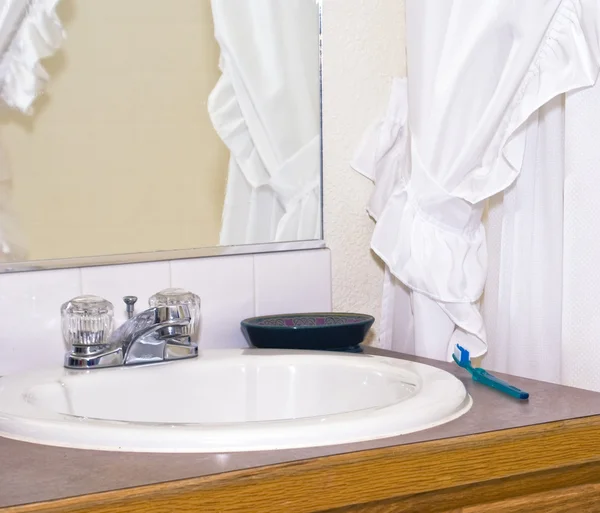 Bathroom sink and toothbrush — Stock Photo, Image