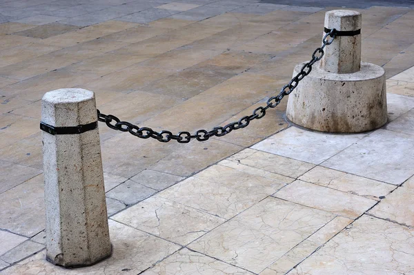 Stock image Chain and stone bollards