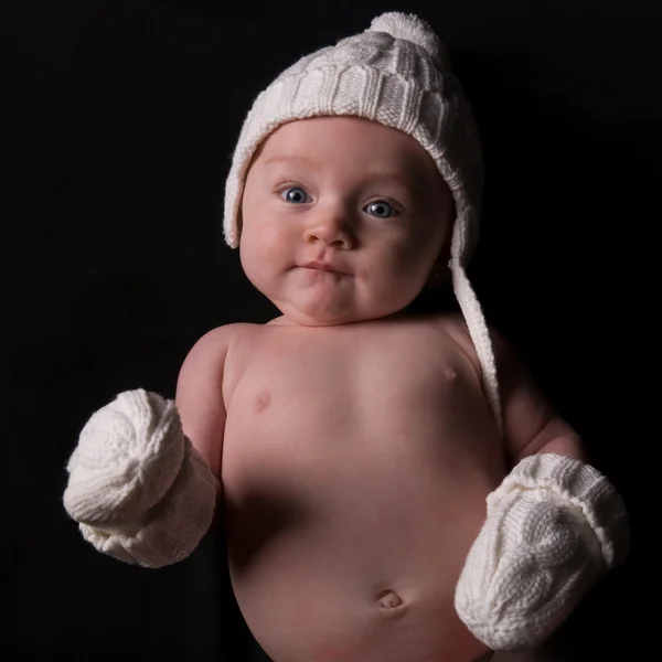 Baby in Hat and Mittens on Black — Stock Photo, Image