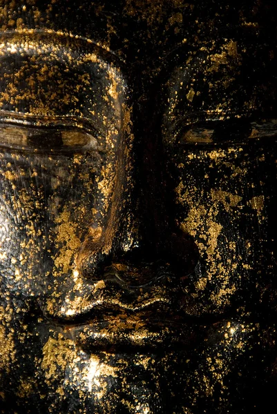 Cara esculpida em flocos de ouro — Fotografia de Stock