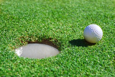 Golf Ball Near Cup clipart