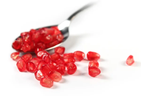 Stock image Spoon with pomegranate seeds isolated