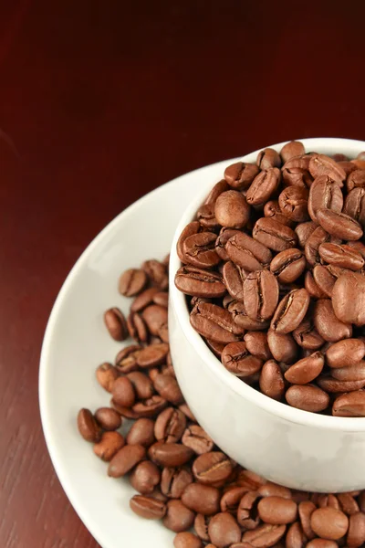 Cap with coffee beans — Stock Photo, Image