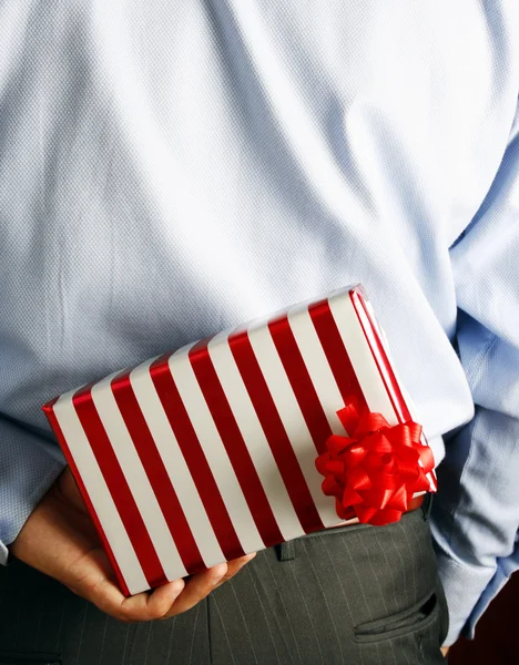 Businessman hiding a gift — Stock Photo, Image