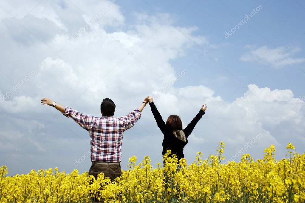 Young couple in a rape field