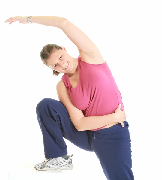 Fit woman stretching isolated over a whi — Stock Photo, Image