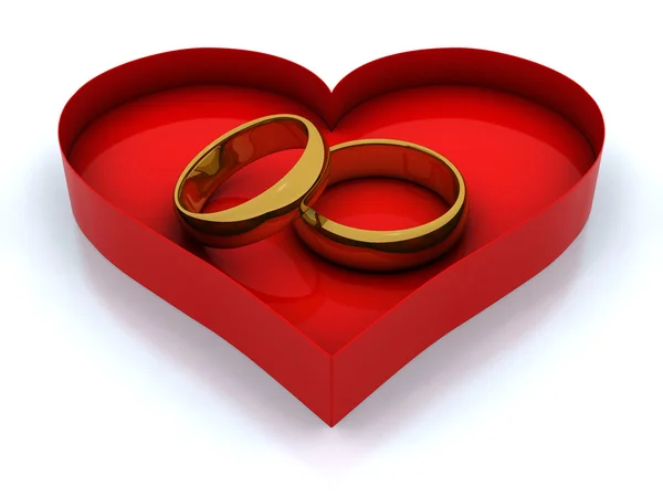 Caja del corazón y anillos dorados — Foto de Stock