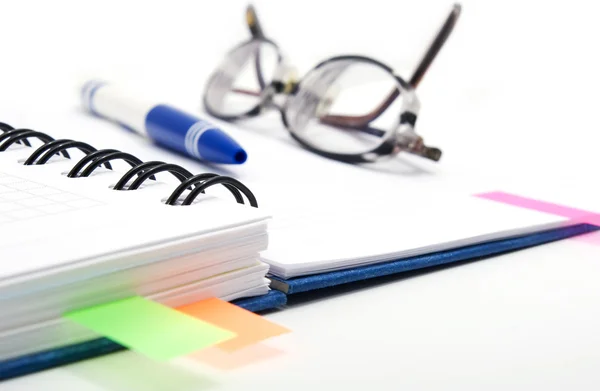 Pen and glasses on notebook — Stock Photo, Image
