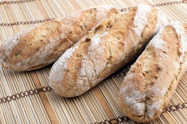 Three fresh bread baguettes clipart