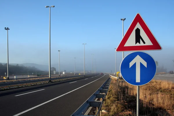 stock image Signs in foggy motorway