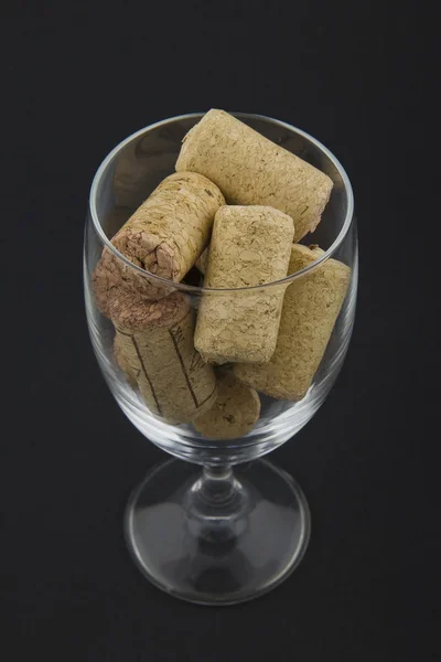 Wineglass filled with corks — Stock Photo, Image