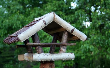 Bird table in the garden clipart