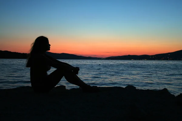 Mulher bonita sentada na praia — Fotografia de Stock