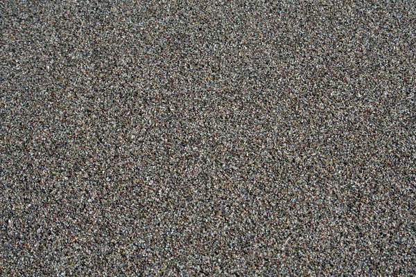 Black sand on the beach — Stock Photo, Image