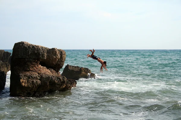 Two men jumping into the water — Stock Photo, Image