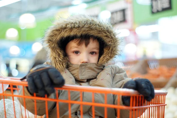 Malý chlapec v nákupní košík — Stock fotografie