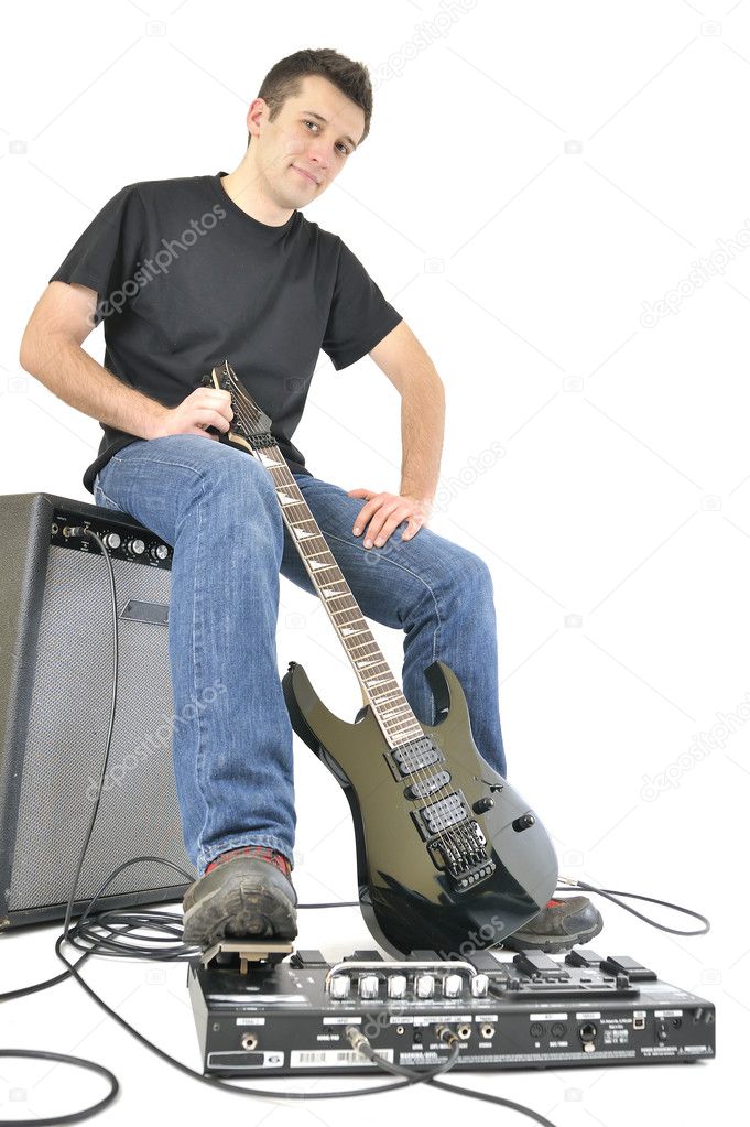 Young with guitar and an amplifier