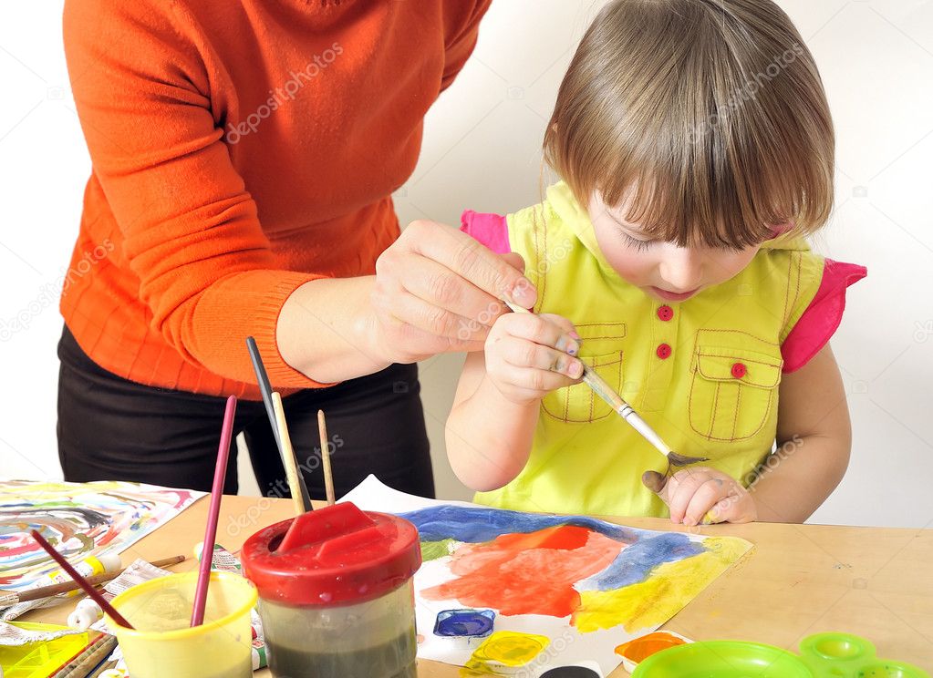 Mother painting with her daughter