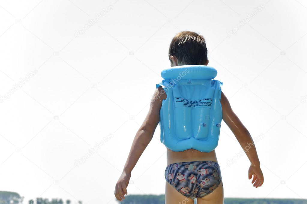 Little boy wearing life vest