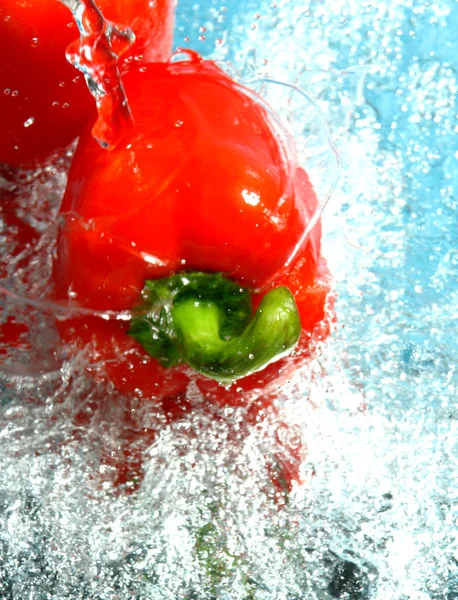 Water and red peppers — Stock Photo, Image