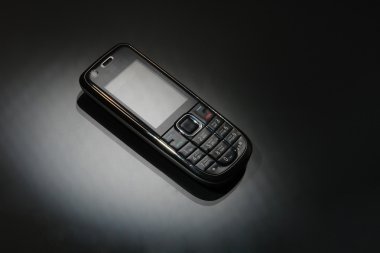 Mobile phone on a black clipart