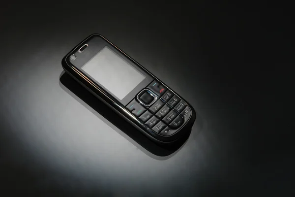 Mobile phone on a black — Stock Photo, Image