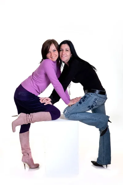Girls are posing on a white cube — Stock Photo, Image