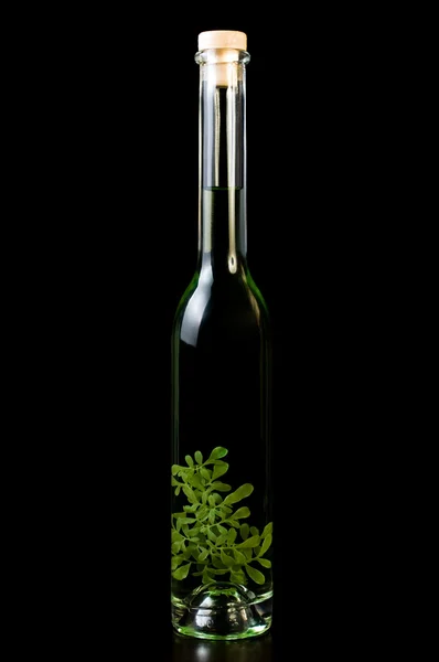 stock image Bottle of vodka, rakija with flower