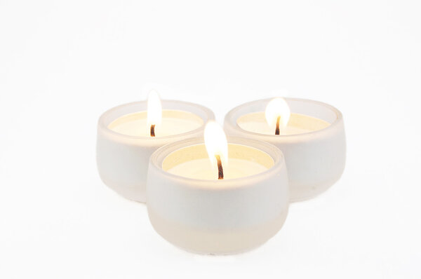 Burning candles on a white background