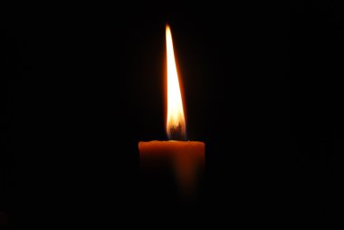 Candle with long flame,isolated on black clipart