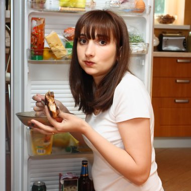 Hungy young woman eating chicken clipart