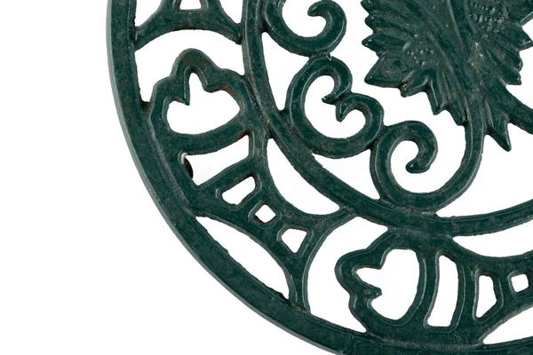 Fragment of an ornate cast iron trivet — Stock Photo, Image