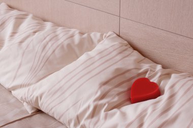 Red heart on pillow. Love and romance clipart