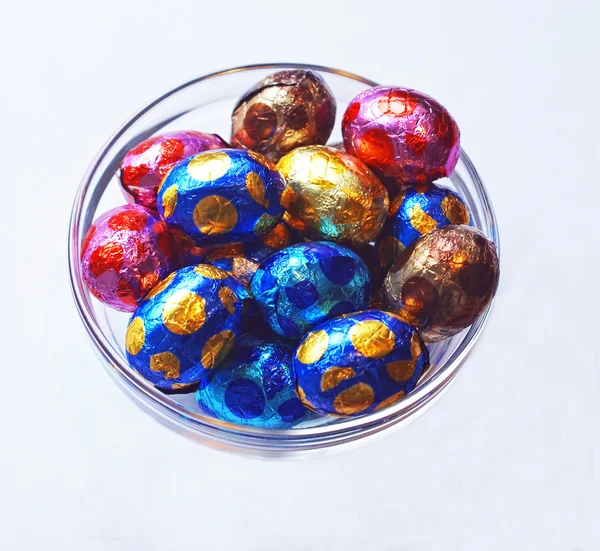 Chocolate eggs in glass bowl — Stock Photo, Image