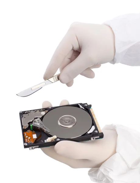 Hard disc and scalpel — Stock Photo, Image
