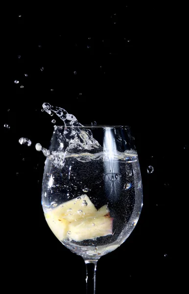 Pineapple pieces falling in water Stock Photo