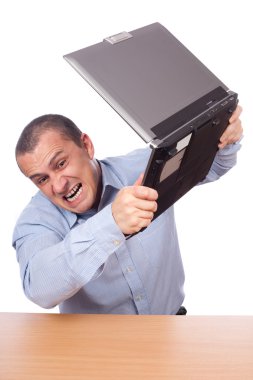 Angry businessman at laptop clipart