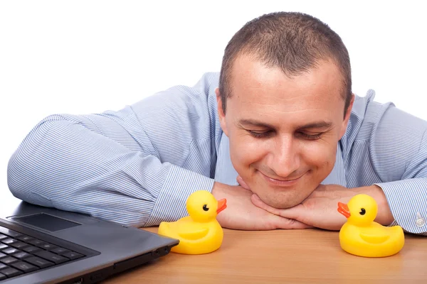 Young businessman and plastic ducks — Stock Photo, Image