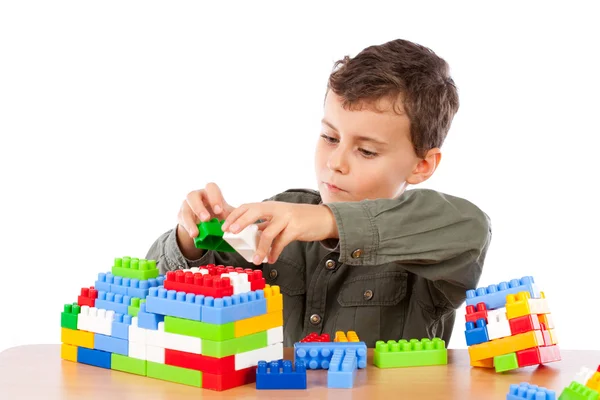 Мальчик играет с пластиковыми кубиками — стоковое фото