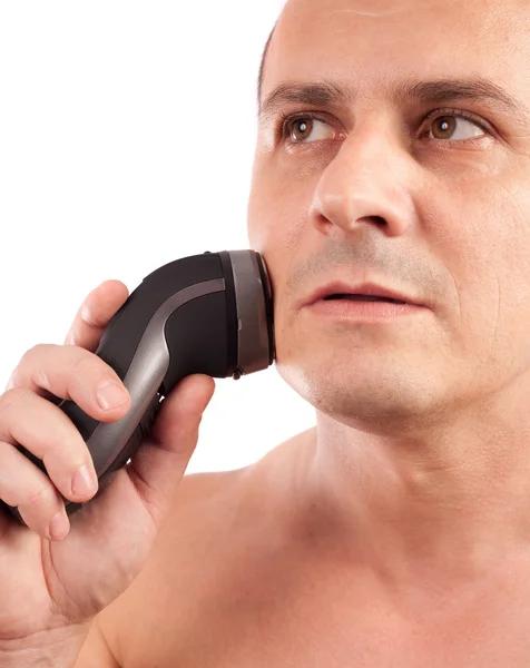 Young man using an electric shaver — Stock Photo, Image