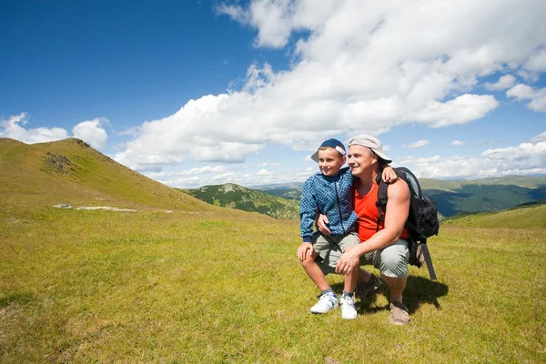 Baba ve oğul dağlarda yürüyüş yapıyor. — Stok fotoğraf