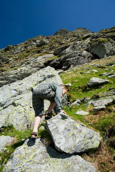 Boy climbing mountain — Stock Photo, Image