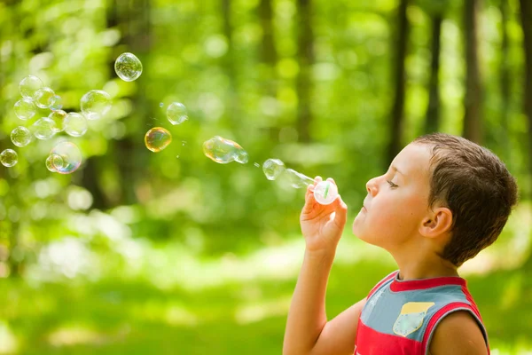 Schattige jongen zeepbellen blazen — Stockfoto