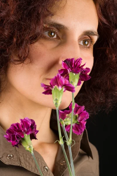 Pelirroja mujer oliendo flores — Foto de Stock