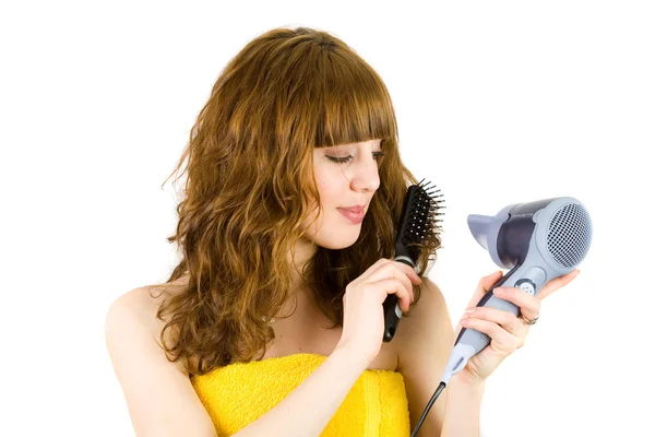 Menina loira usando secador de cabelo — Fotografia de Stock