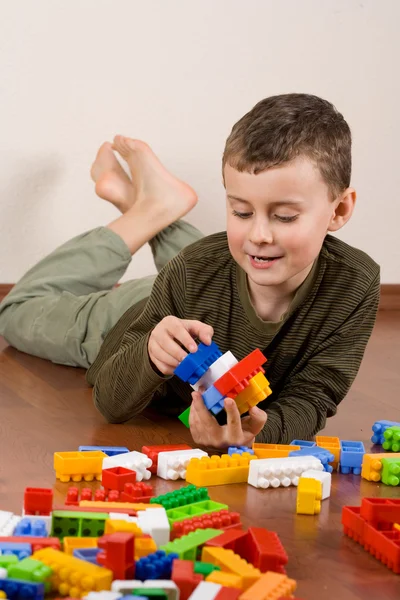 Cute kid playing with cubes — Stock Photo, Image