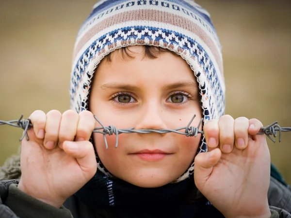stock image Boy behind barbed wire