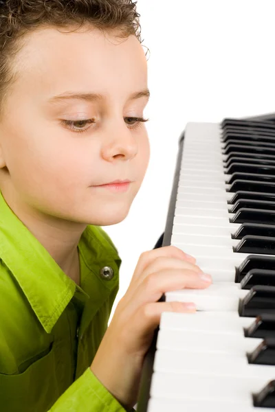 Cute kid playing piano — Stock Photo, Image