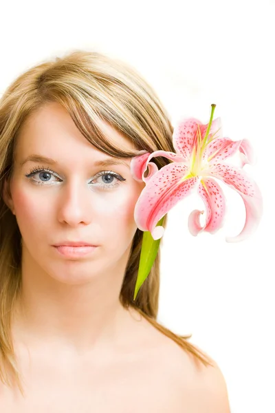 Portrait of a beautiful blonde woman with a lily in hair — Stock Photo, Image