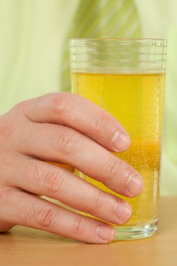 Hand on a glass with fresh drink